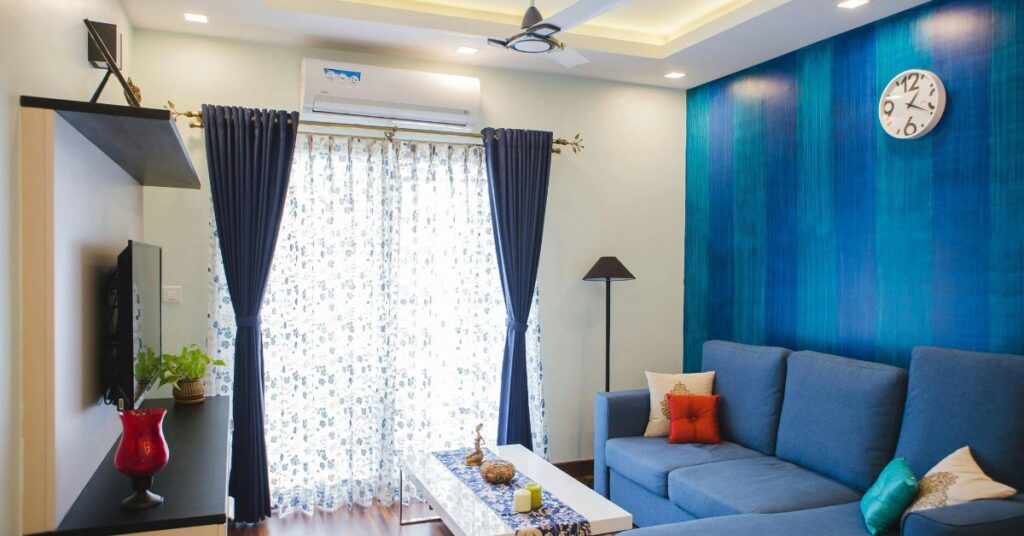 Budget living room decoration ideas for Indian homes with accent wall and sofa styling